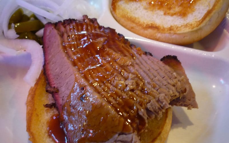 A sliced beef brisket sandwich from a Dallas barbecue joint
