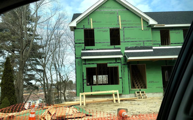 A new home under construction with framing and sheathing in place