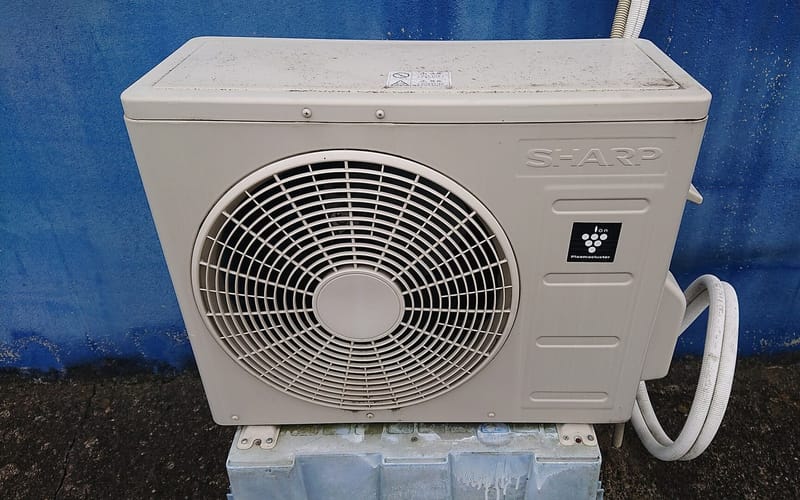 An outdoor air conditioner unit mounted outside a house